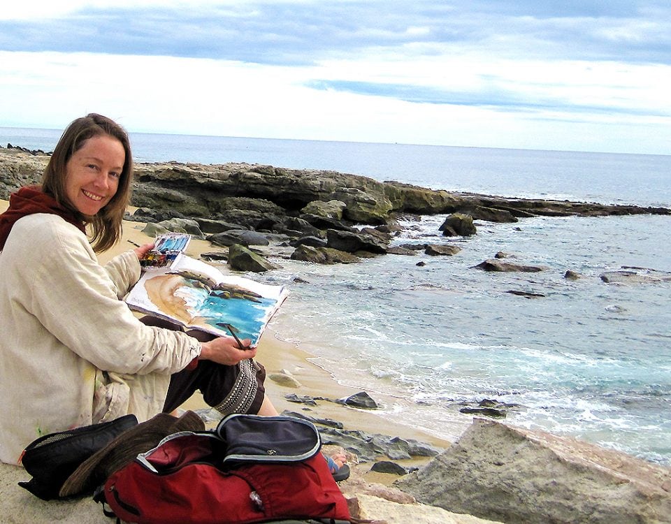 kellie day painting in her art journal on the beach in mexico
