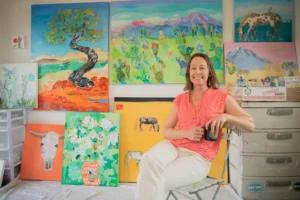 Kellie Day in her studio surrounded by her wonderful paintings.